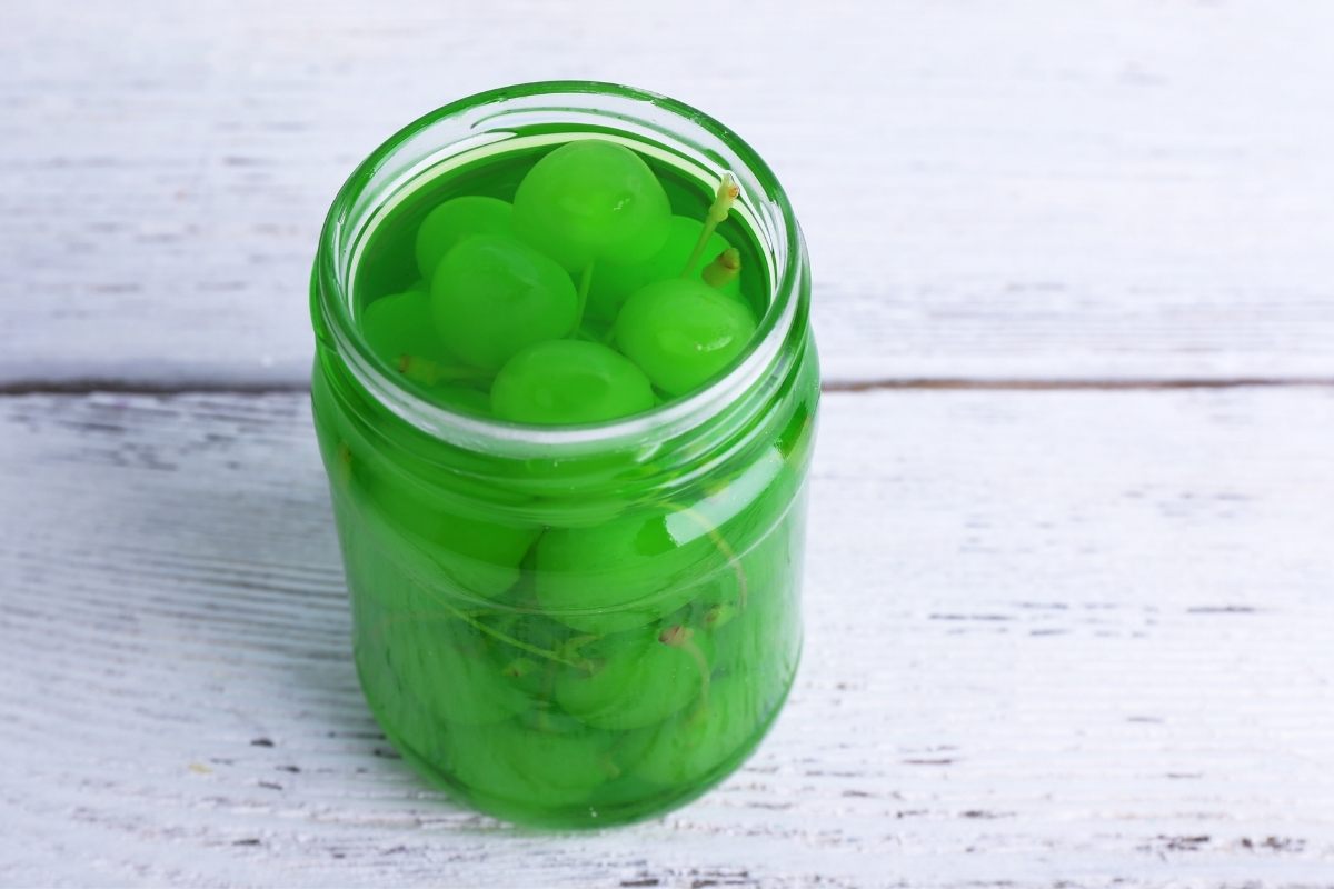 A jar of green Maraschino cherries.