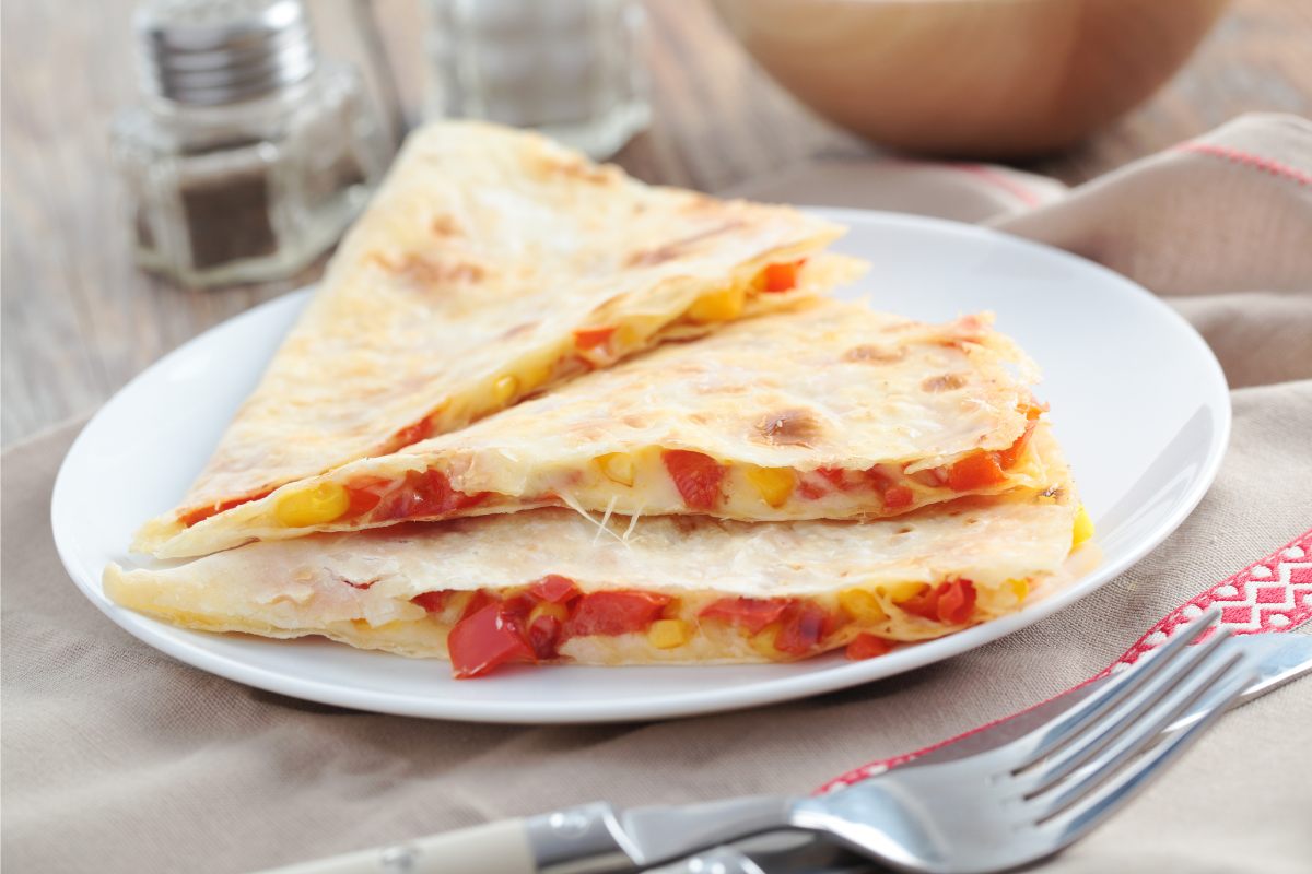 Pizza quesadillas with tomato sauce, cheese and toppings, cut into triangles.