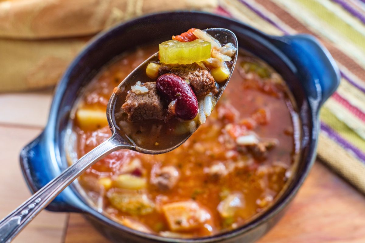 Slow cooked beef, bean and vegetable soup in the pot.