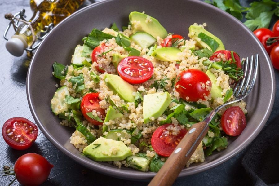 Quinoa salad with spinach, cherry tomatoes and avocado.