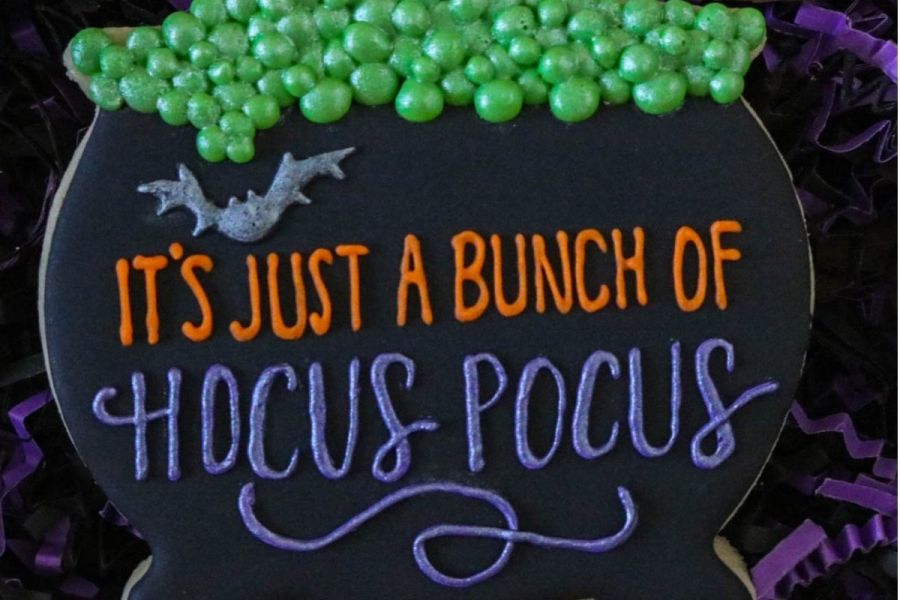 A sugar Halloween cookie with the words It is just a bunch of hocus pocus.