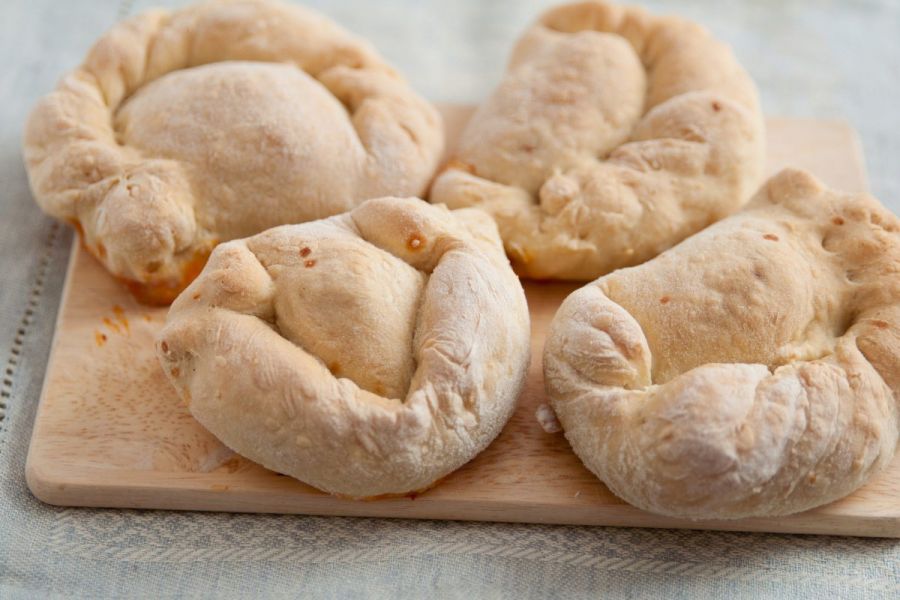 Four individual pizza roll puffs, similar to mini calzone pizzas.