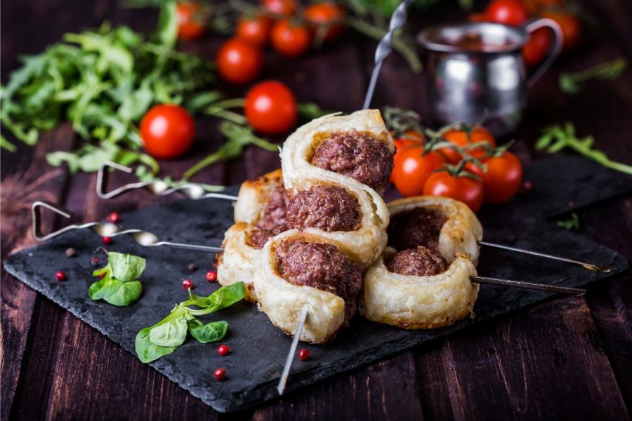 Two dough and meatball kebabs.