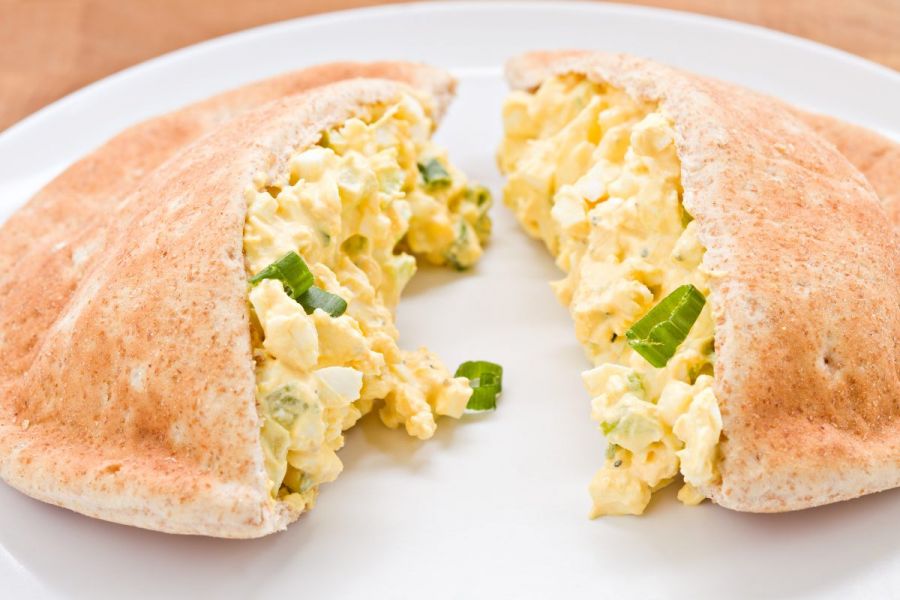 Pita bread halved and filled with egg salad.
