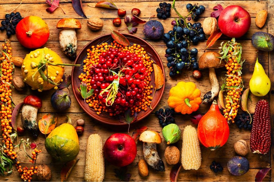 A selection of autumn food, including apples, figs, grapes, mushrooms, nuts and more.