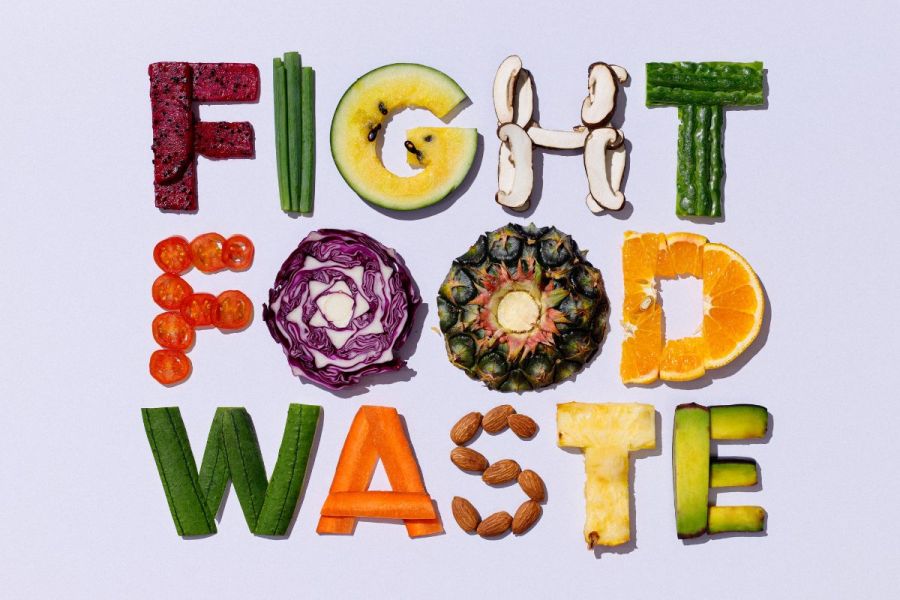 Fight food waste words written with vegetables and fruit.