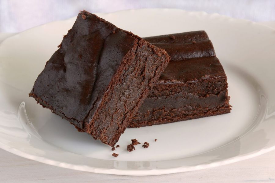 A plate with two gluten free brownies.